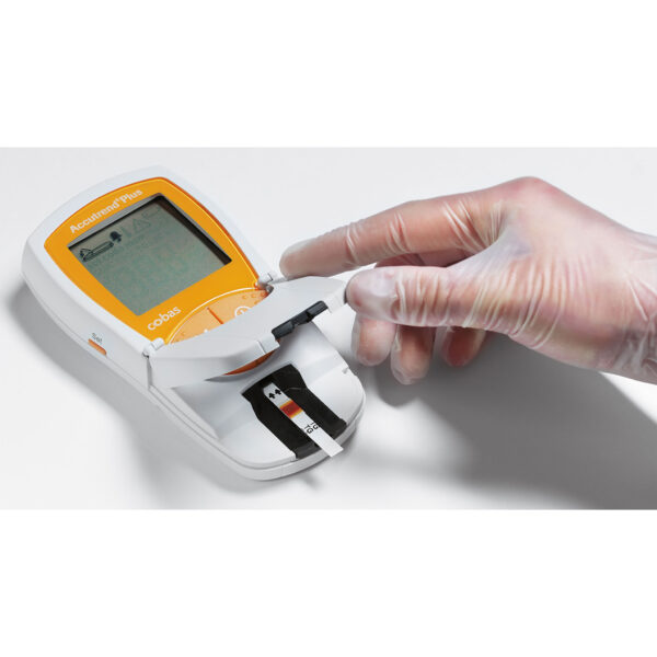 An image presenting orange Accutrend Plus device, which measure the blood sample.